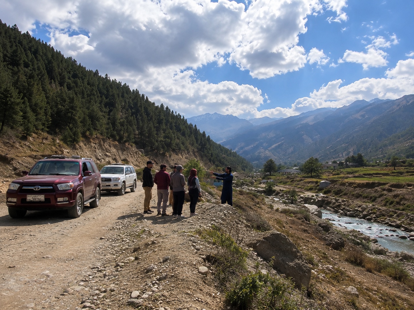 Travelers and an Afghan guide stopping on a mountain road